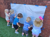kids drawing on a paper wall