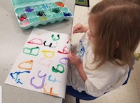 girl painting letters
